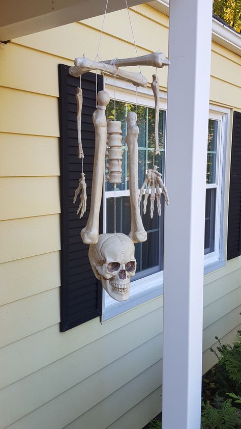 Boneyard Halloween Decorations, Patio Decorating Ideas Halloween, Bone Mobile Wind Chimes, Halloween Bones Decorations, Bag Of Bones Halloween Ideas, Bone Mobile, Bone Wind Chime, Skeleton Bathroom, Skeleton Ideas