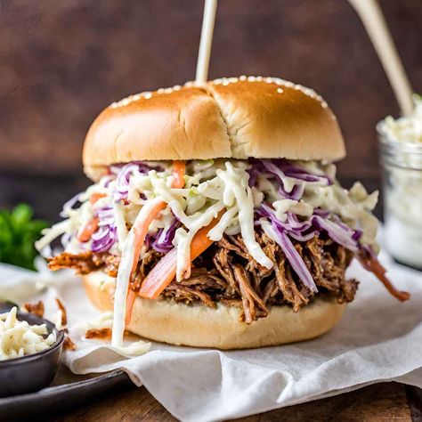 Juicy, tender pork pickled and slow cooked to perfection, topped with a creamy coleslaw and served on a toasted bun. An oldie but most definitely a goodie. Best Pulled Pork Crock Pot Recipes Easy, Pulled Pork Coleslaw, Pulled Pork With Coleslaw, Pulled Sandwiches, Pulled Pork And Coleslaw, Pulled Pork Bowl, Best Pulled Pork Slow Cooker, Pull Pork Sandwich Recipes, Coleslaw Topping For Pulled Pork