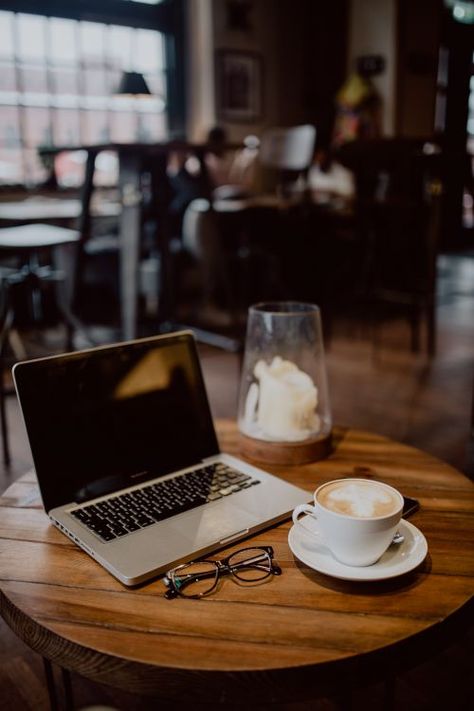 Cup of coffee & MacBook laptop, glasses on table in cafe Coffee Slogans, Coffee Shop Photography, Coffee Shop Logo, Coffee Shop Aesthetic, Laptop Lifestyle, Macbook Laptop, Coffee Photography, Aesthetic Coffee, A Cup Of Coffee