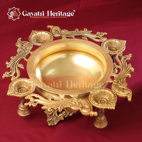 Brass Peacock Urli with Bell – Elegant Traditional Centerpiece | Gayatri Heritage Elevate your home with the elegance of our handcrafted Brass Peacock Urli, featuring a bell for that perfect traditional touch. A true masterpiece for any decor, adding timeless charm to your space. Visit our website for more! #gayatriheritage #brassstatues #brassart #brassdecor #interiordecor #handcrafted #traditionaldecor #peacockurli #centerpiece #gayatrihandicrafts #homedecor #artisanal #customproducts Brass Urli, Brass Peacock, Brass Art, Brass Statues, Brass Bells, Brass Decor, Elevate Your Home, Traditional Decor, Interior Decorating