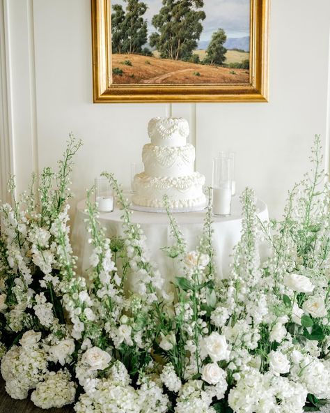 all white cake table surrounded by lush greenery and ivory florals Cake Table Florals, Cake Table Flowers, Wedding Cake Table Decor, Cake Florals, Wedding Cake Table Decorations, Table Florals, Wedding Cake Display, Sweetheart Table Wedding, Cake Table Decorations