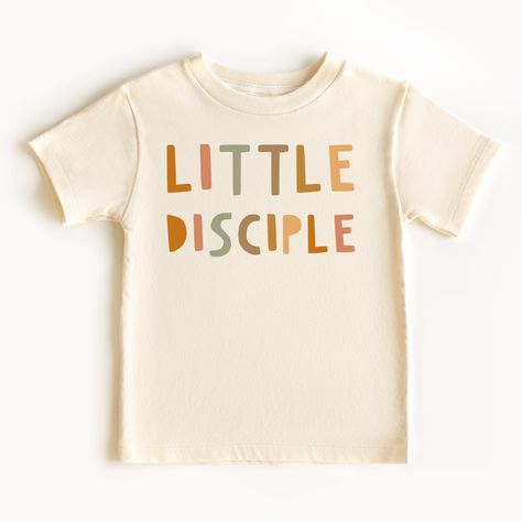 "Introducing our charming and meaningful \"Little Disciple\" kids shirt, specially designed to inspire and empower young hearts with its delightful message. This shirt is perfect for children who are proud to embrace their faith and strive to follow in the footsteps of their spiritual role models. -BODYSUIT- .: 100% combed ringspun cotton  .: Infant unisex fit .: Light fabric (5.0 oz/yd² (170 g/m .: Tear-away label -TODDLER & YOUTH TEE- .: 100% Airlume combed and ring-spun cotton  .: Extra light fabric (4.2 oz/yd² (142 g/m .: Retail fit .: Tear-away label  Various factors such as your screen resolution, color settings, display type, lighting conditions during photoshoot, and the fact that each person sees colors differently, can all affect how the colors are displayed on the Internet. Cons Christian Toddler Shirts, Kids Christian Shirts, Christian Tshirt Design Ideas, Christian Kids Shirts, Church Merch, Jesus Kids, Church Branding, Christian Clothing Brand, Kids Shirts Design