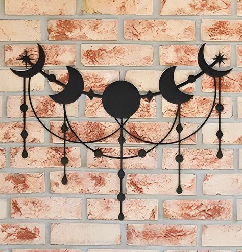 "Our moon phase metal wall art wall hanging is sure to elevate your home with celestial style and is sure to be a beautiful piece of decor for your home. Made with 18 gauge steel and powder coated in your choice of 5 colors, this sign is built to withstand the elements for years of enjoyment. Add a touch of elegance to your home on the inside, outside, or both! 💥CAN ONLY SHIP WITHIN THE CONTINENTAL USA. ALL ORDERS FOR HAWWAII, ALASKA, AND ALL USA TERRITORIES WILL BE CANCELED💥 ⭐️Check out our other moon phase metal sign with geometric patterns: https://www.etsy.com/listing/1531798226/moon-phase-wall-hanging-moon-phase-wall ⚒️Material: 18 Gauge Steel 🎨5 Color Options (Black, Red, White, Copper, Silver) 6 Sizes - 36\", 30\", 24\", 18\", 14\", 12\"  📍Ships from the US with Free US shipping Metal Moon Art, Moon Phases Silhouette, Moon Cycle Wall Hanging, Wooden Moon Phase Wall Decor, Moon Phases Art Wall Hangings, Gold Moon Phase Wall Hanging, Moon Wall Art, Moon Decor, 3d Wall