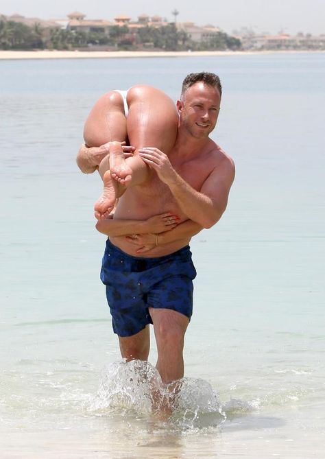 Illegal lift… James carries Ola out of the water Dubai Holiday, Dubai Holidays, Dakota Fanning, Strictly Come Dancing, Lift And Carry, The Passion, In Dubai, Daily Mail, Swim Trunk