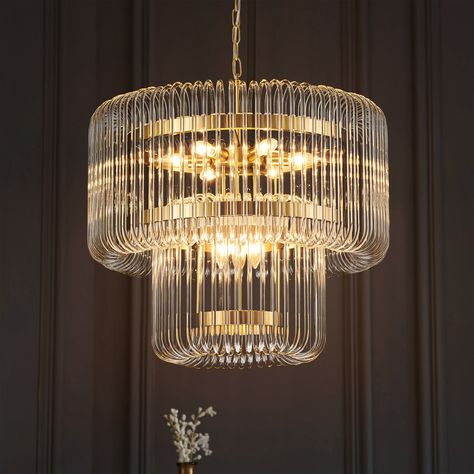 The stunningly elegant ceiling light is crafted from brass gold metal and two cascading layers of curved glass tubes. A modern glam lamp that embellishes any room while giving off an ambient glow. Its frame, a modern marvel, is hugged by transparent glass loops that cascade light across your space, creating a warm, inviting ambiance that’s both chic and cheerful. This Chandelier is a grand scale statement piece with125 curving rods seemingly suspended around tiered rings of brushed brass. As the Closet Chandelier Walk In, Glam Lamp, Modern Living Room Chandelier, Chandelier With Fan, Closet Chandelier, Glam Lamps, Metal Belts, Modern Contemporary Chandelier, Chandelier Designs