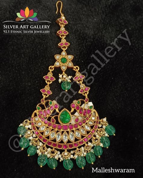 Let the twinkling manga tikka with emerald & ruby stone speak of history, art & splendor on the glory for ever Store Location: silverartgallery @ Malleshwaram https://www.whatsapp.com/business/ Open: 10.00am to 9.00pm For enquiry call us: +919036884252 #chokernecklace #anklets #fashion #goldpolishedsilverjewellery #jumkaearrings #kada #payal #exclusivecollection#silverartgallery #threadjewellery #pearljewellery #newecollection #kundanjewellery #czstonejewellery #southindiajewellery #wedd Manga Tikka, Jumka Earrings, History Art, Thread Jewellery, Ruby Stone, Kundan Jewellery, South India, The Glory, Cz Stone