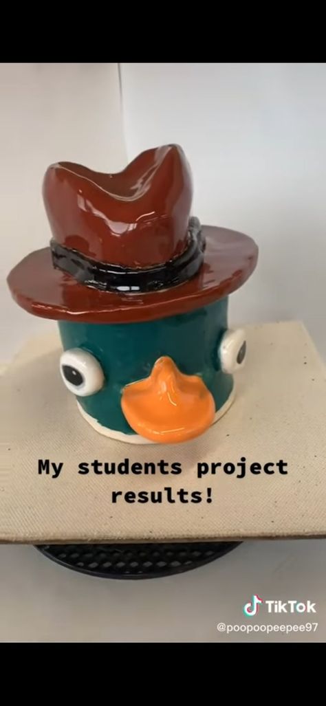 Perry The Platypus Clay Mug, Perry The Platypus Ceramic, Clay Face Pot, Pop Culture Ceramics, Creative Pinch Pot Ideas, Creative Pinch Pots, Perry The Platypus Clay, Clay Daisy, Pottery Pinch Pot