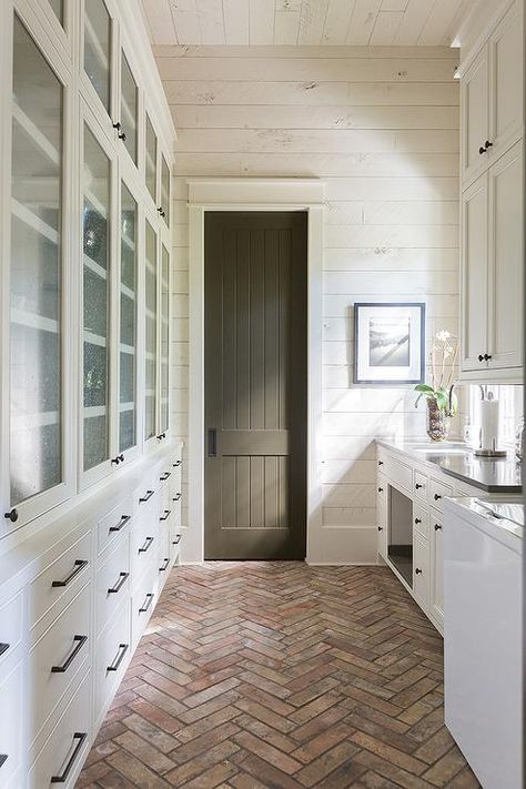 A red brick herringbone pantry floor boasts white drawers fitted with oil rubbed bronze hardware and positioned beneath stacked seeded glass cabinets. Brick Herringbone Floor, Kitchen Minecraft, Herringbone Brick Floor, Bloxburg Cottage, Wood Shiplap Wall, Elegant Cottage, Kitchen Cottage, Kitchen Bloxburg, Brick Floor