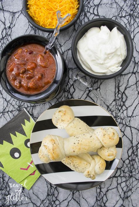 It's Halloweek! Host A Halloween Chili Bar - Revel and Glitter Halloween Chili Bar, Bone Breadsticks, Chili Bar Party, Halloween Chili, White Halloween Party, Chili Bar, Frozen Dinner Rolls, Frozen Rolls, Dried Basil Leaves