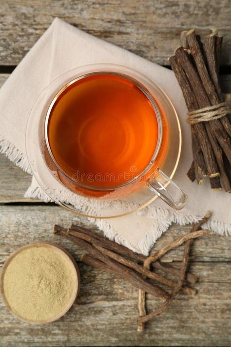 Aromatic licorice tea in cup, dried sticks of licorice root and powder on wooden table, flat lay stock photography Licorice Tea, Food Flatlay, Aesthetic Background, Licorice Root, Organic Health, Wooden Table, Wooden Tables, Licorice, Flat Lay