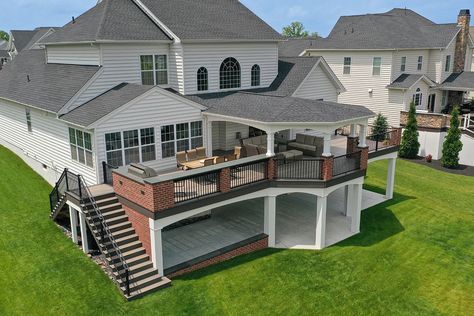 Open porches are the standard porch that many people envision when they want to cover their deck or patio. Tiered Decks And Patios, Walk Out Bedroom Patio, Deck Off Back Of House Second Floor, Big Deck Ideas, Two Story Deck Ideas, Second Story Covered Deck Ideas, Deck With Patio Underneath, Backyard Platform, Deck To Patio Transition