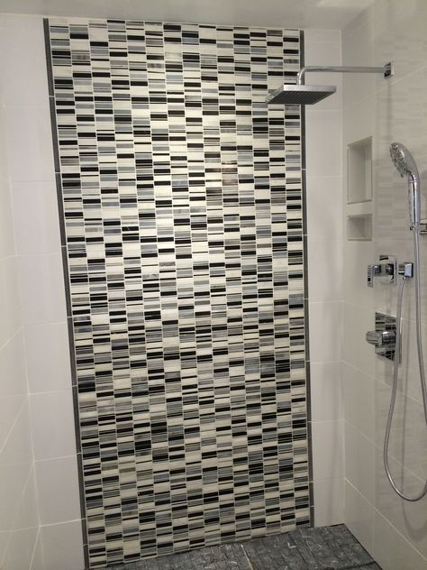 Our master shower.    White glossy porcelain 12 x 24 tile on the end walls.    Grey, black and white mosaic marble tiles on the back with grey pencil tile to separate.   The white porcelain tile wraps around.    Soap and shampoo niche with white tile.   Delta Argo faucets and shower head.    Adding a shower shield still. Shower Shield, Shampoo Niche, Pencil Tile, Black And White Mosaic, White Porcelain Tile, Mosaic Marble, Bathroom Upgrade, Master Shower, White Mosaic