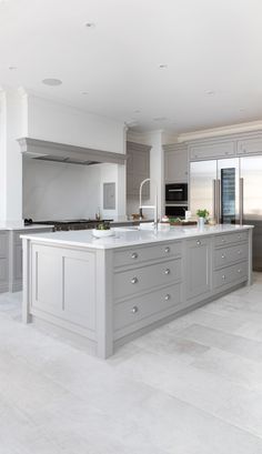 Modern open plan kitchens deserve a statement island. This larger than life island has been crafted to suit the dimensions of the space. It features solid corner pillars for a classic look. With its soft grey finish and pale Silestone work surface, integrated and discreet storage, and stylish built-in sink it’s a great place to prep food, without missing a moment of family life. Modern Kitchen Open Plan, Tom Howley, Fitted Kitchens, Kitchen Luxury, Grey Kitchen Designs, Open Plan Kitchen Living Room, Kitchens Luxury, Kitchen Dining Living, Kitchen Room Design