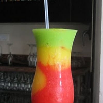 First, start by making the red portion of the drink by combining 1 ounce light rum, 4 ounces strawberry daiquiri mix and 1 cup of ice in a blender. Summertime Cocktails, Strawberry Daiquiri Mix, Frozen Drink, Sour Mix, Light Rum, Strawberry Daiquiri, Party Punch, Blue Curacao, Frozen Drinks