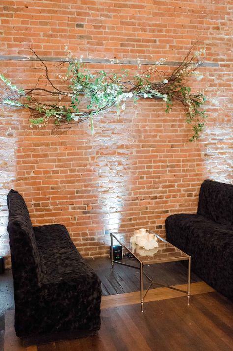 Add interest to your event space with organic hanging branch sculptures. | FLORA NOVA DESIGN SEATTLE Small Event Space Decor, Small Event Space Design, Event Space Decor, Event Space Design, Cozy Couch, Event Room, Green Garland, Small Dining Table, Antique Doors