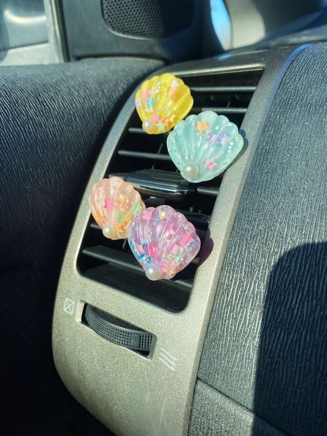 LOOKING FOR WAYS TO SPICE UP YOUR CAR INTERIOR? Check out ShopCarCandy! We offer a variety of handmade interior car accessories. Crystal vent clip charms, car fresheners, car mirror charms, and window decals, all handmade with love! You may also like these crystal vent clips!  https://etsy.me/3INirkJ You may also like these resin vent clips! https://etsy.me/3JVGqzy ----------------------------------------- PRODUCT DETAILS Materials - This product is made from resin and glitter Quantity - This listing is for ONE shell charm Size - The size of this product is roughly one inch Vent Clip Direction - All vent clips are made for cars with horizontal vents (vents shown in photos). They can still fit vertical vents, but will be sideways from what is shown in the photos. If you would like a vent cl Car Mirror Charms, Interior Car Accessories, Mirror Charms, Car Interior Diy, Hippie Car, Girly Car Accessories, Car Deco, Beach Cars, Car Vent Clip