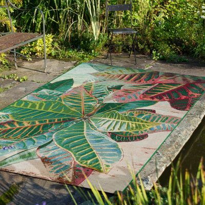 Ground your living room or porch in coastal style with this tropical area rug with billowing leaves in green and pink. Made from polypropylene, it's fade and stain-resistant, making it a great choice for areas with lots of foot traffic. The low pile height ensures easy maintenance, while the intricate design adds a touch of visual interest to your decor. When it's time for a refresh, simply hose it down and lay it flat to dry. We recommend pairing it with a rug pad to add extra cushion, as well Tropical Area Rugs, Patio Rugs, Indoor Outdoor Rug, Beachcrest Home, Green And Pink, Outdoor Area Rug, Indoor Outdoor Area Rugs, Floral Rug, Coastal Style