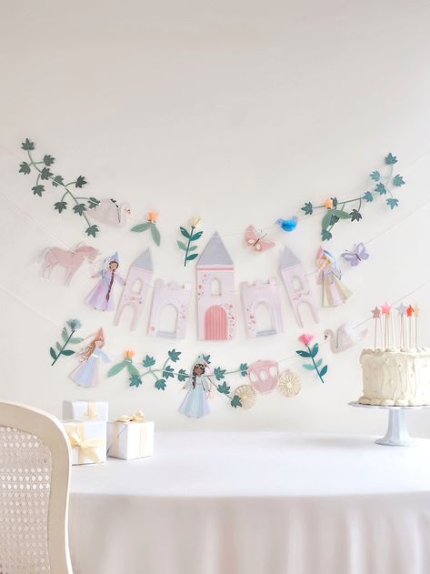 Create an enchanted fairy tale setting with this most majestic garland! Featuring princesses, a castle, a unicorn and a carriage, it will look magical at your princess party. It's also a beautiful decoration for the bedroom – make your kids feel like royalty all year round. Details The garland is created from 2 pieces Three princesses with organza and satin ribbon embellishments Crepe paper and tissue paper flowers Shiny gold metallic thread on the flowers and unicorn Ivory tissue paper for the Princess 3rd Birthday Party Food, Forever A Princess Birthday Party, Tiara Birthday Party Ideas, Princess Birthday Party Crafts, Princess Theme Party Decorations Diy, Minimalist Princess Birthday Party, Princess Party Welcome Sign, Fairy Princess Birthday Party Decoration, 5th Birthday Princess Theme