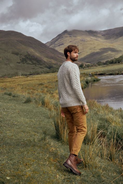 A symbol of Ireland past and present, the Inisheer Traditional Aran Sweater is a timeless addition to your wardrobe. Made with 100% Merino wool, the quality of this authentic Irish gem cannot be rivalled, its is a true Irish hero Aran piece. Much like its namesake, the Inisheer Aran Sweater captures the essence of Ireland in all of its glory. With a beautiful combination of traditional Aran stitches such as honeycomb, moss and cable, this piece is inspired by the past while remaining firmly root Irish Men Aesthetic, Mens Scotland Outfit, Farm Men Outfit, Outdoor Wear For Men, Men’s Outdoorsy Style, Men In Nature Aesthetic, Sweater Male Outfit, Men’s Outdoor Poses, Irish Fashion Mens