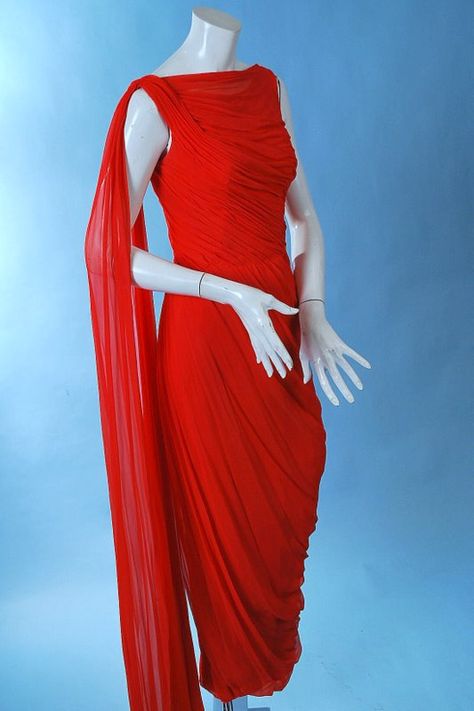 Glamorous Ceil Chapman red silk chiffon classical goddess gown, dating to the 1950's. Masterful fluid draping of the silk chiffon to emphasize the curves of the female form, with cowl neckline, fan tail chiffon fluttering at the back. Lined in rayon crepe with stays thru the bodice, back metal zipper, long chiffon streamer off one shoulder. In excellent uncleaned as found vintage condition with one pindot ink spot lower front skirt. This has not been dry cleaned. Chest measures 36", waist 28", h Chapman Red, Ceil Chapman, Goddess Gown, Vintage Fashion 1950s, Fashion 1950s, Red Chiffon, Chiffon Gown, Cowl Neckline, Vintage Vogue