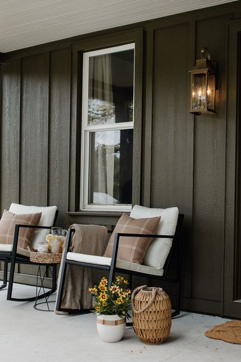 Front Porch Styling Modern, Outdoor Board And Batten Siding, Board And Batten Modern Exterior, Tan Board And Batten Exterior, Board And Batten Porch, Dark House Colors Exterior, Black Porch Ideas, White Cabin Exterior, Cabin Outdoor Ideas