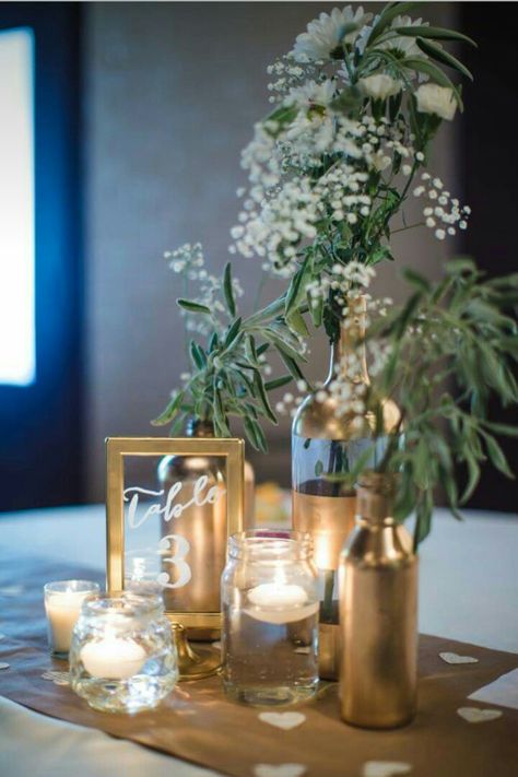 Gold centerpieces Good Centerpieces, Black Gold And Green Centerpiece, Wine Bottle Wedding Decor Centerpieces, Simple Banquet Centerpieces, Wine Bottle Party Decorations, Green Gold And White Centerpieces, Elegant Gala Centerpieces, Greenery Ring Centerpiece, Elegant Black And Gold Centerpieces