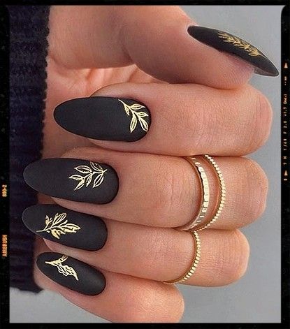 Black velvet nails with gold leaves Black Nails With Gold Leaves, Black Nails With Gold Swirls, Spring Nails 2023 Black, Black With Gold Accent Nails, Black And Gold Drip Nails, Black Art Deco Nails, Wedding Nails Black And Gold, Black And Golden Nails Acrylic, Tan Nails With Black Design