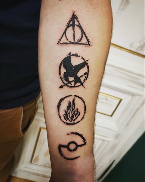 4 in 1 tattoo for geeks. Potter, Hunger Games, Divergent, Pokemon symbols. Matching Pokemon Tattoos, Divergent Tattoo Ideas, Pokémon Tattoo Ideas, Pokemon Symbols, Gaming Tattoo Ideas, Mockingjay Tattoo, Pokemon Tattoo Ideas, Hunger Games Tattoo, Divergent Tattoo