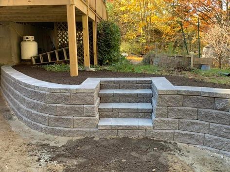 Concrete Retaining Wall With Stairs, Curved Retaining Wall With Steps, Patio On Sloped Yard Backyards, Sloped Backyard Patio Ideas, Sink Holes In Yard, Stone Retaining Wall With Steps, Retaining Wall On Sloped Yard, Landscape Design Retaining Wall, Retaining Wall Steps Sloped Backyard