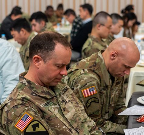 The words "bow your heads as we pray" echoed off the fellowship hall of Four Chaplains Memorial Chapel at the U.S. Army Garrison (USAG) Humphreys annual the prayer luncheon had begun. With folded hands and closed eyes, participants sat at their candle-lit tables. Fellowship Hall, Army Chaplain, Patriotic Poems, Stories Quotes, Folded Hands, Staff Sergeant, The Prayer, Closed Eyes, Light Table