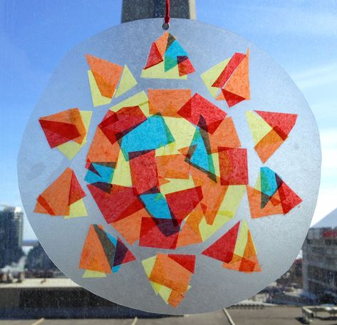 The sun suncatcher, finished, trimmed to a circle and hanging in a window. Diy Contact Paper, Sun Catchers Diy, Sun Suncatcher, Paper Sun, Suncatcher Craft, Sketch Videos, Bee Embroidery, Butterfly Drawing, Crafts For Kids To Make