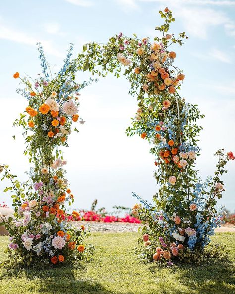 Wildflower Trellis Wedding, Wild Flower Reception, Wedding Arch Flowers Wildflowers, Outdoor April Wedding, Floral Half Arch Wedding, Beach Floral Wedding, Colorful Wedding Altar, Spring Wedding Isles Decoration, Wildflower Wedding Bridesmaids Dresses