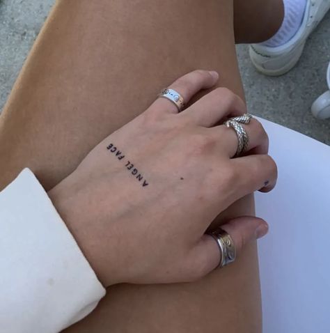 Phrase Hand Tattoo, Hand Words Tattoo, Word Angel Tattoo, Hand Text Tattoo, Angel Tattoo Hand, Hand Tattoo Writing, Angel Writing Tattoo, Writing On Hand Tattoo, Angel Tattoo Word