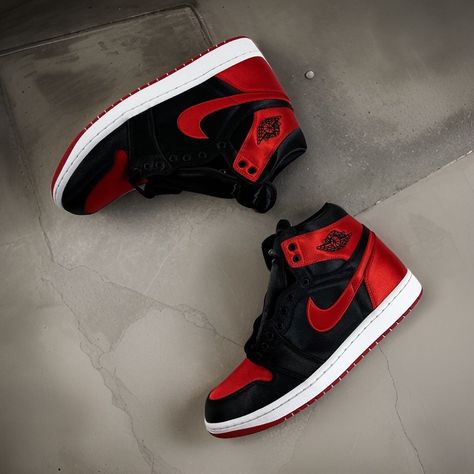 The Air Jordan 1 High OG "Satin Bred" is a must-have for any sneakerhead. With its luxurious satin upper and classic black and red colorway, this shoe is sure to turn heads wherever you go. #AirJordan1 #SatinBred #BlackandRed Hype Shoes Men, Shoes You Need, Jordan 1 Outfit Men, Nike Air Jordan Shoes, Nike Fashion Shoes, Pretty Shoes Sneakers, Jordan Shoes Retro, All Nike Shoes, Nike Shoes Jordans