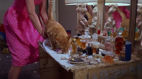 Revlon red nail polish (vintage bottle) and Guerlain L’heure bleue perfume on Holly Golightly's dressing table. Screencap source. 50's Aesthetic, Blonde Icons, Holly Golightly, Architecture Tattoo, Red Nail Polish, Vintage Bottle, Small Shelves, Breakfast At Tiffanys, Small Bottles