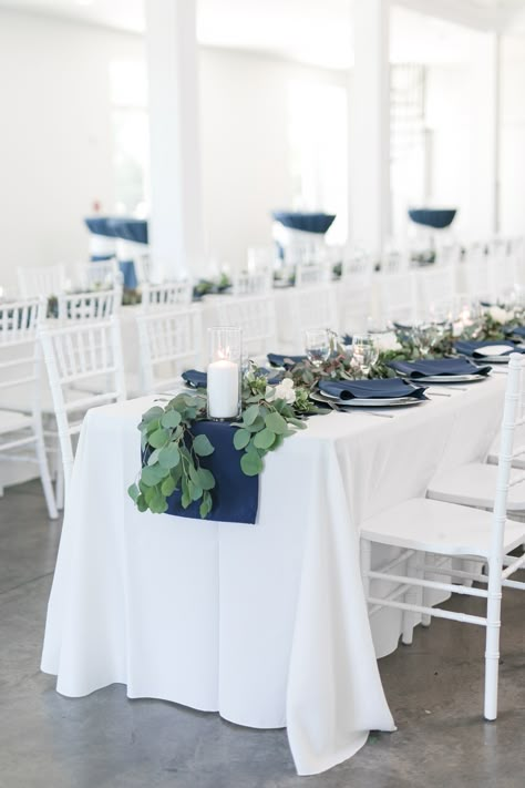 Navy Blue And Greenery Wedding Theme, White And Navy Centerpieces, Steel Blue Wedding Reception, Navy And White Tablescape, Blue Themed Wedding Centerpieces, Navy And White Wedding Table Decor, Navy Wedding Accents, Simple Wedding Style Receptions, Navy Blue And White Wedding Table Decor