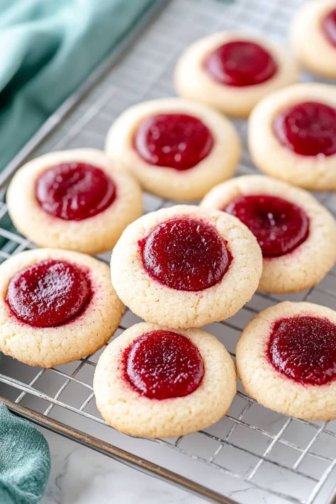 These buttery, soft raspberry thumbprint cookies with sticky jam center bring a little fruity magic to every bite. They're almost too good to share! Raspberry Bow Tie Cookies, Jam Diagonal Cookies, Jam Butter Cookies, Raspberry Pillow Cookies, Desserts With Jam, Cookies With Jam In The Middle, Raspberry Jam Cookies, Strawberry Thumbprint Cookies, Raspberry Thumbprint