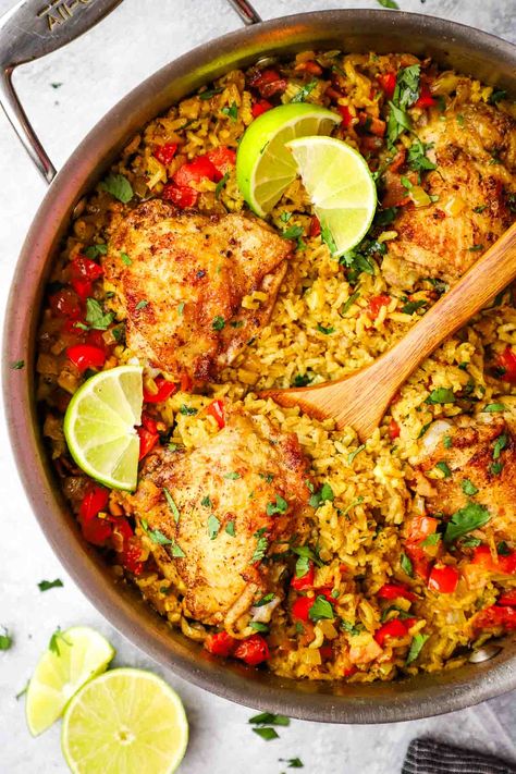 This one pan Cuban chicken and rice is so easy and full of flavor. Chicken thighs seasoned with lime, coriander and cumin are baked over turmeric-scented rice for a complete, delicious meal that that whole family will love. One Pan Cajun Lime Chicken, Cuban Chicken And Yellow Rice, Chicken And Lime Recipes, Cuban Yellow Rice Recipe, Cuban Chicken Recipes, Cuban Chicken And Rice, Chicken Thigh And Rice Recipe, Cuban Rice, Chicken And Yellow Rice