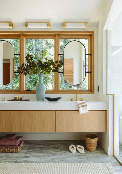 The primary bathroom at the River House is all about serene luxury, with a sauna, custom finishes, and even mirrors placed in front of the windows to maximize light while keeping privacy. I wanted this master bathroom to feel like a retreat, with natural materials and calming colors that make it perfect for unwinding. From choosing the right layout to adding personal touches, each detail was carefully planned to blend relaxation and style. Come take a look at how it all came together! Window Mirror Bathroom, Taking Cara Babies, Fresh Bathroom, Small Storage Cabinet, Indoor Sauna, Sophisticated Bathroom, Vanity Design, House Deck, Primary Bathroom