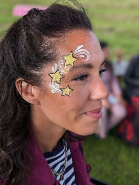 Space Themed Face Painting, New Year’s Eve Face Paint, Galaxy Face Painting, Stars Face Paint, New Year Face Paint, Uv Face Paint Ideas Simple, New Years Face Paint, Glow In The Dark Face Paint Ideas, Taylor Swift Face Paint