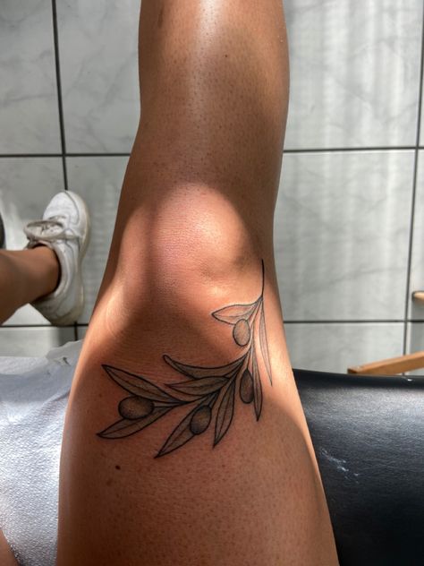 Leaf Tattoos For Women Leg, Knee Tattoo Plant, Leg Leaves Tattoo, Olive Branch Tattoo Thigh, Food Tattoo Sleeve, Olive Branch Leg Tattoo, Plus Size Tattoo Placement, Around The Knee Tattoos Women, Tattoo Branch