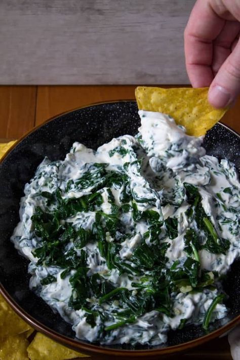 This Creamy Garlic Spinach Dip is great for a gathering, even if it's just amongst your household. We're sneaking in some leafy greens with plenty of cream cheese and garlic. Serve with crunchy tortilla chips or raw veggies for an awesome sharable dip. #spinachdiprecipe #diprecipe #partyfood #appetizerrecipe Raw Veggies, Chili Cheese Dips, Spinach Dip Recipe, Bacon Dip, Garlic Spinach, Meatless Recipes, Easy Chili, Kinds Of Cheese, Chili Cheese