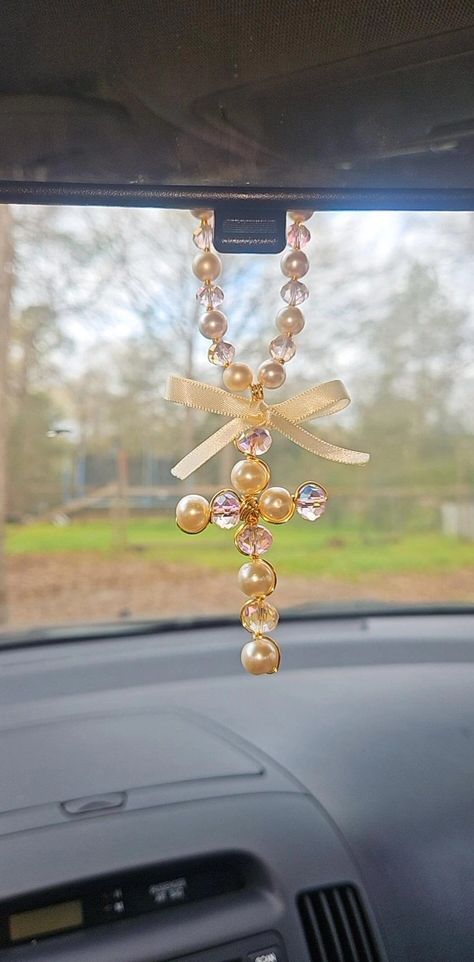 The brilliant and elegant blessings of the Crystal Cross for the Car Rearview Mirror envelop your vehicle in an atmosphere of protection and good energy. Each carefully selected crystal emits radiant sparkles that illuminate the interior of the car, creating a feeling of peace and harmony. Whether during the day or night, the dazzling effect of the blessings of the cross will remind you that you are always surrounded by divine light while driving. Let your car be a sacred refuge with this Crystal Cross for the Car Rearview Mirror!" They are perfect to give as a gift, for memories of Baptism, birthday, Wedding, first communion, you can even use it in the office, bedroom anywhere you want, these Blessings will catch the attention of whoever sees it Remember that the photos are taken in Natur Jesus Decor, Car Mirror Hangers, Gold Car, Mirror Hangers, Travel Charms, Crystal Cross, Girly Car, Rear View Mirror Charm, Diy Cross