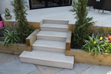 Raised deck Millboard terrace with steps leading down to a sun terrace. Raised Garden Terrace, Garden With Steps Down, Raised Patio Garden Ideas, Raised Terrace Patio, Patio With Steps Up To Garden, Raised Garden Patio, Step Down Garden, Raised Patio With Steps, Decking With Steps