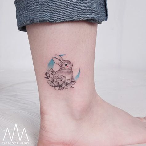 Rabbit, Flowers and Blue Crescent Moon on Ankle by Tattooist Nanci Moon And Rabbit Tattoo, Rabbit Flower Tattoo, Bunny On The Moon Tattoo, Bunny With Flowers Tattoo, Bunny Moon Tattoo, Moon Rabbit Tattoo, Bunny Tattoo Ideas, Rabbit Tattoo Design, Hase Tattoos