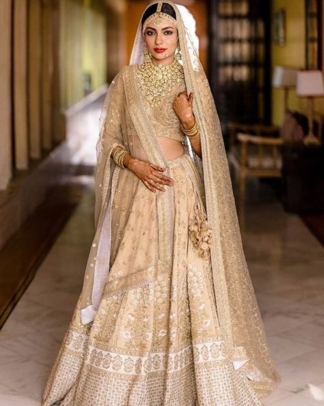 Pretty beige-ivory lehenga by Sabyasachi for the wedding day. See more on wedmegood.com #wedmegood #indianwedding #indianbride #bridallehenga #bridallehengacholi #sabyasachi #sabyasachibride #sabyasachimukherjee #sabyasachiofficial #lehenga #lehengacholi Golden Bridal Lehenga, Ivory Lehenga, Bridal Lehenga Designs, Sabyasachi Lehenga, Bridal Lehenga Collection, Indian Bridal Lehenga, Designer Bridal Lehenga, Indian Bridal Dress, Lehenga Collection