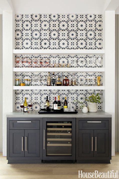 Opt for graphic tiles: Cement tiles from Ann Sacks, installed behind the Thermador gas cooktop and the dry bar beside the dining table, add the right amount of focal-point pattern. Click through for more amazing photos of this farmhouse kitchen. Wine Rack, Wine, Bar, Black And White, Wall, White, Black