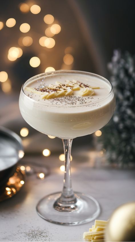 Holiday cocktail in a glass with chocolate garnish, set against a warm, festive background. Snowflake Martini Recipe, Vodka Martini Recipes, Snowflake Martini, Cocktails Made With Vodka, Holiday Martinis, Martini Recipes Vodka, Gin Martini, Christmas Martini, White Chocolate Liqueur