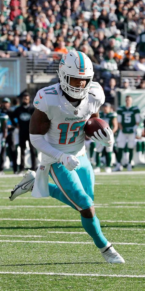 Download a free wallpaper of Jaylen Waddle, a professional American football player for the Miami Dolphins. Perfect for fans of the Dolphins and footb... Jaylen Waddle Wallpaper Dolphins, Dolphins Nfl Wallpaper, Jaylen Waddle Wallpaper, Tyreek Hill Wallpaper Dolphins, Jaylen Waddle Dolphins, Dolphins Wallpaper, Miami Dolphins Wallpaper, Cool Football Pictures, Jaylen Waddle