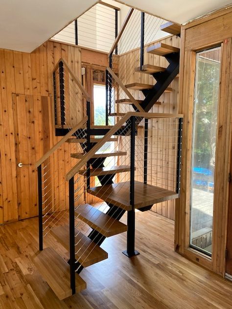 Designed for a tight space is this steel stringer switchback floating stairs with landings. Space Saving Basement Stairs, Floating Stairs To Loft, Stairs For Tight Spaces Loft, Stairs With Landing Small Spaces, Spiral Staircase Basement, Stair For Small House, Stair Design For Small Space, Small Home Stairs Design, A Frame Staircase